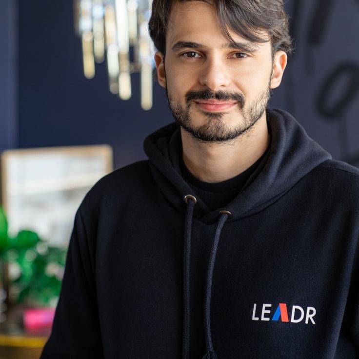 Asha Rao, Lead Design Curator at MeadowMintGlint, reviewing corporate floral arrangements